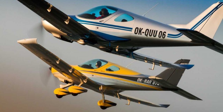 Two light aircraft fly in close formation